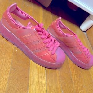 A see through pink Adidas size 6.5 low top with 3in platform and gently used.